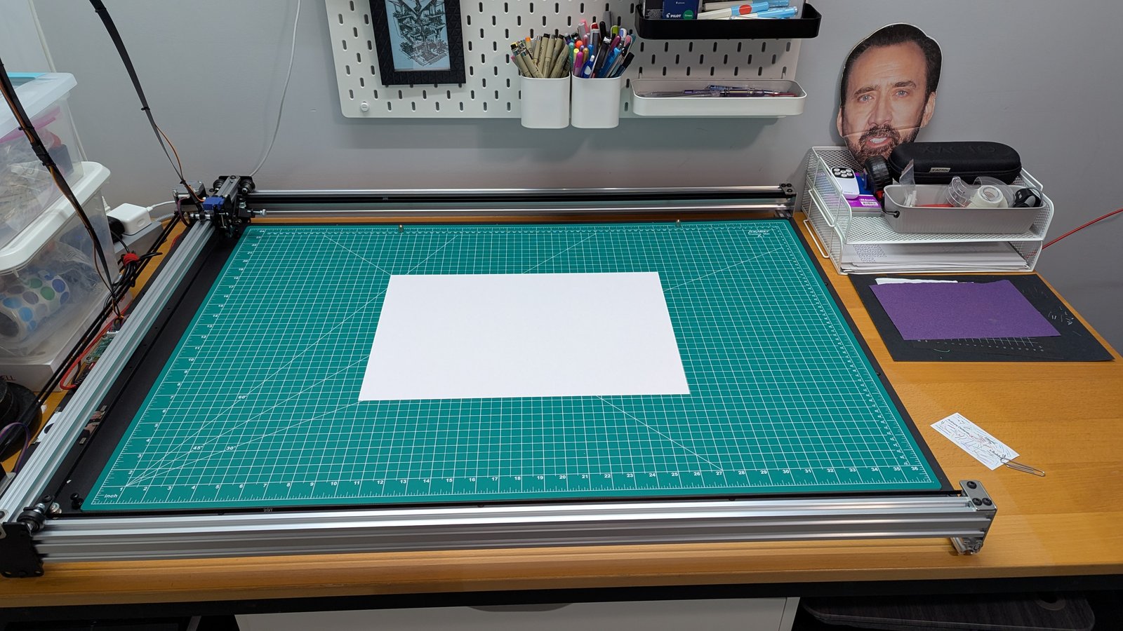 The same A3 format on the 2436: the sheet sits on a full A1 cutting mat, and the mat fits the bed with room to spare.