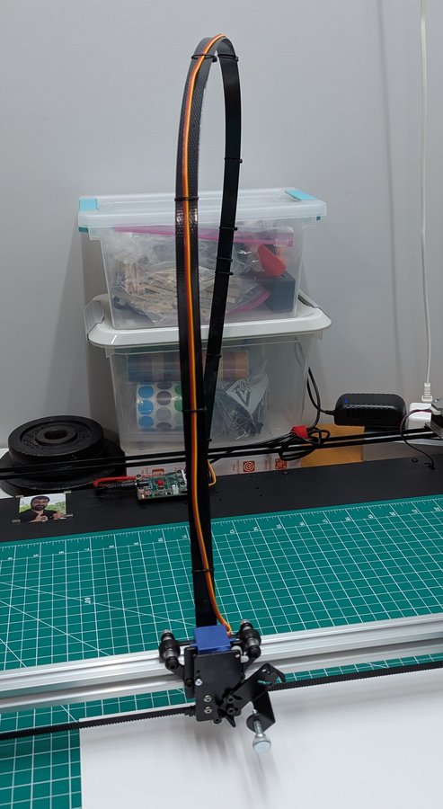 The pen-lift servo's ribbon arcs well above the carriage and sweeps with it. Give it 18 inches of clearance.